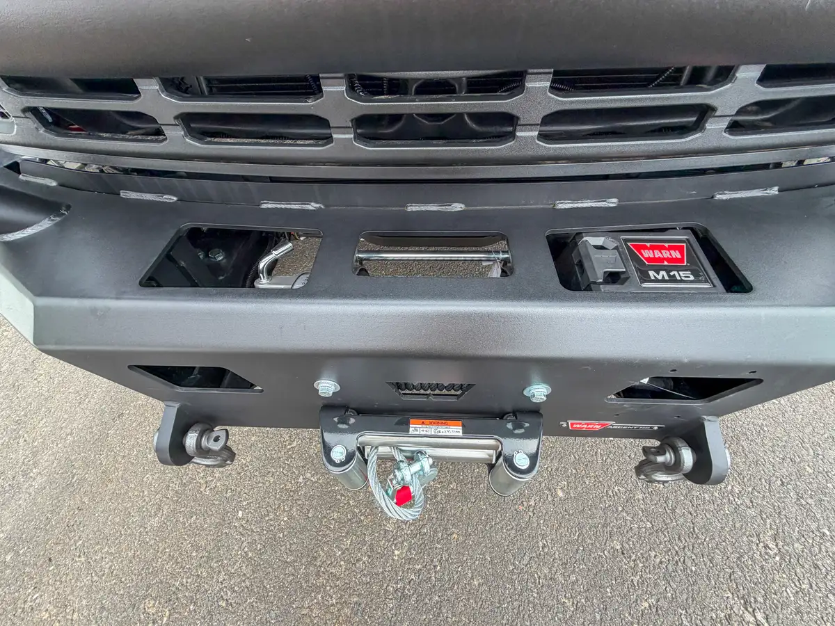 Front bumper winch, hooks, and tow point detail close-up.